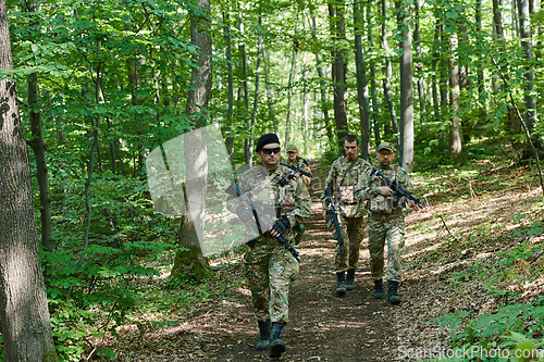 Image of A specialized military antiterrorist unit conducts a covert operation in dense, hazardous woodland, demonstrating precision, discipline, and strategic readiness