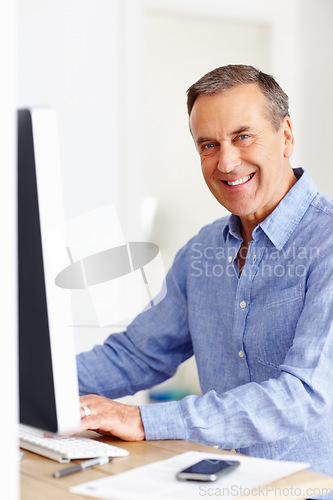 Image of Mature man at desk with computer, portrait and happy networking on email, typing and planning budget. Smile, paperwork and senior businessman in office with invoice, bills and online business audit.