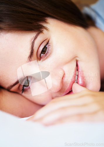 Image of Thinking, smile and woman on bed in morning for sleeping, dreaming and comfortable at home. Happy, thoughtful and face of person in bedroom resting, nap and wake up for health, wellness and calm
