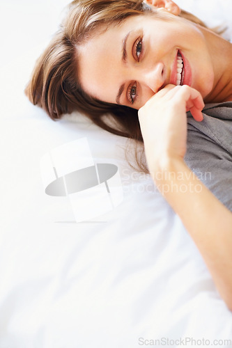 Image of Relax, blanket and portrait of happy woman on bed for sleeping, dreaming and comfortable. Smile, home and face of person in bedroom resting, nap and wake up for health, wellness and calm in morning