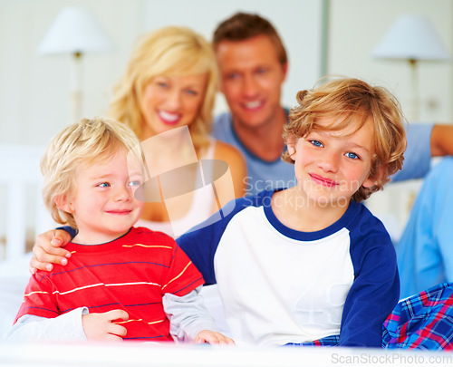 Image of Happy, portrait and parents with boys on bed for bonding, relaxing and spending time together. Smile, love and young mother and father resting with kids from Australia in bedroom at family home.