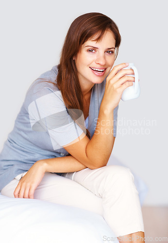 Image of Happy, coffee and portrait of woman in home for relaxing, calm and breakfast on weekend. House, apartment and person smile with mug for warm beverage, tea and drinking caffeine in bedroom in morning