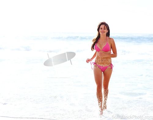 Image of Sunshine, running and happy woman in bikini on beach for summer vacation, travel and tropical island. Relax, playing and girl with smile at ocean for holiday with waves, sun and energy in Hawaii.