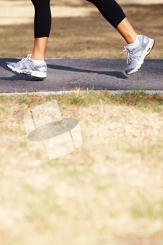 Image of Running, cardio and shoes of woman in nature for fitness, speed and health challenge. Wellness, sports and workout with female runner training in outdoor path for exercise, fast and performance