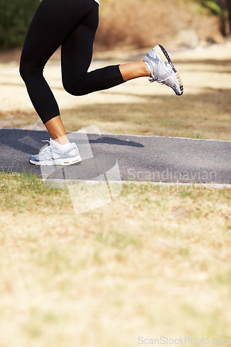 Image of Running, health and shoes of woman in nature for fitness, speed and cardio challenge. Wellness, sports and workout with female runner training in outdoor path for exercise, fast and performance