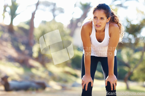 Image of Thinking, fitness and tired woman in a park for workout break, recovery or resting after cardio run. Sports, fatigue and female runner stop to breathe in a forest for wellness, training or exercise