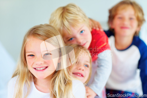 Image of Portrait, happy or love with brother and sister sibling children on a bed in their home together. Family, smile or bonding with young boy and girl kids in the bedroom of an apartment on the weekend