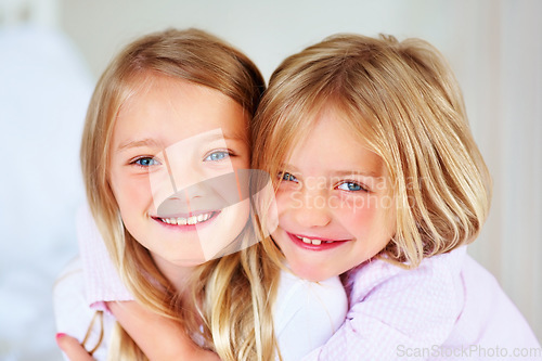 Image of Portrait, sisters and hug indoors with love for relax wellness, happiness and sibling support in home. Children, girls and smile face for fun morning in embrace, family and bonding for care in house