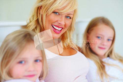 Image of Happy, portrait and mother with children on bed for bonding, relaxing and spending time together. Smile, love and young mom chilling and resting with girl kids from Australia in bedroom of house.