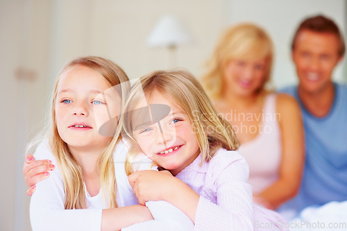 Image of Portrait, siblings or sisters for hug together on bed, relax wellness and happiness with care support in home. Girls, embrace and smile face for bonding with proud parents and morning love in house