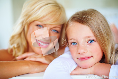 Image of Happy, portrait and mother with girl on bed for bonding, relaxing and spending time together. Smile, love and young mom chilling and resting with kid or child from Australia in bedroom of family home