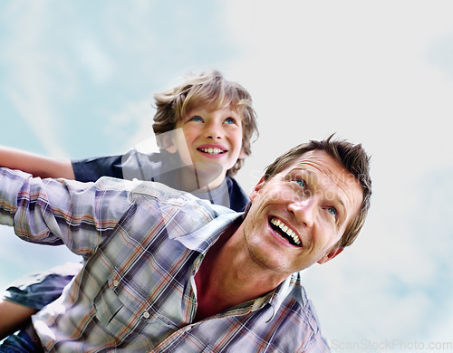 Image of Father, son and smile outdoor with piggyback for bonding, relationship and freedom with blue sky in nature. Family, man and boy child with playing, care and love for happiness, peace and support