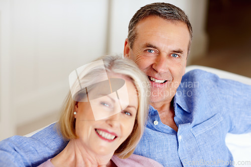 Image of Smile, portrait or senior couple in home with love on sofa to bond or hug in a marriage commitment together. Happy, face or mature people in retirement with care or support in living room to relax