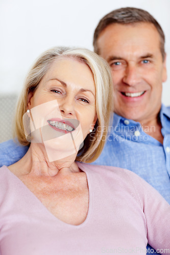 Image of Senior, couple and portrait or happy on sofa with support, relationship and marriage in retirement home. Elderly, man and woman with smile on couch in living room with trust, care and love in house