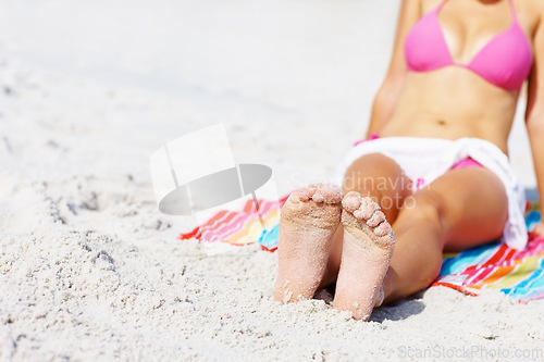 Image of Woman, feet and bikini at beach, relax and sand for sunshine, summer and mockup space with towel. Girl, freedom and outdoor for vacation, holiday or color for sunbathing, health or wellness in Naples