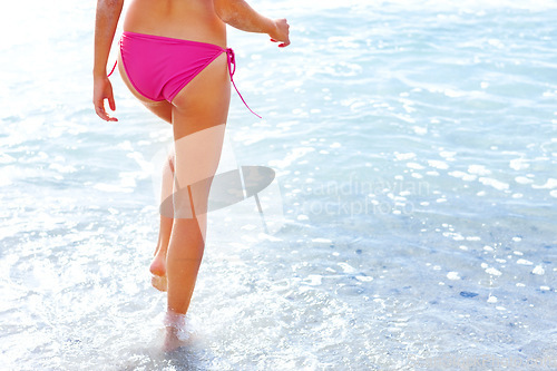 Image of Walking, legs and woman in bikini on beach for summer vacation, travel adventure and tropical island. Relax, waves and girl at calm ocean for holiday with sunshine and nature and freedom in Hawaii.