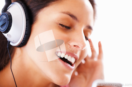 Image of Music headphones, singing and woman face listening to playlist track, audio podcast or wellness sound. Freedom, eyes closed and closeup girl, student or singer streaming media, song or radio app