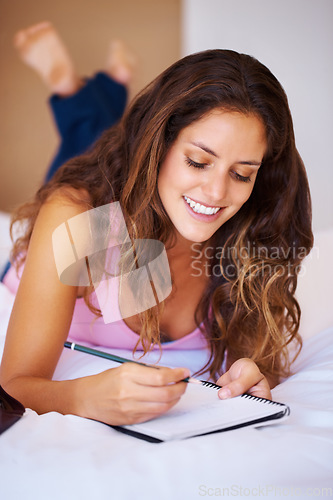 Image of Young, woman and writing in diary in bedroom with idea for vision of future. Female person, student or creative by notebook for journaling, goals or aspiration in home for peace, wellness or relaxing