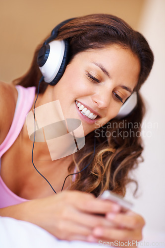 Image of Smile, headphones and young woman listening to music, playlist or radio at home for entertainment. Happy, technology and female person from Canada relax and streaming song or album in her apartment.