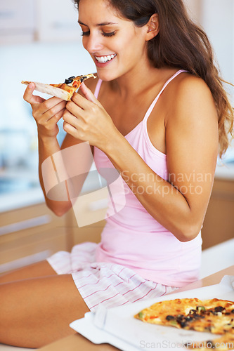 Image of Smile, eating and young woman with pizza for dinner, supper or lunch on weekend at home. Happy, meal and female person from Canada in pajamas enjoying fast food in kitchen at modern apartment