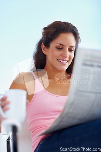 Image of Happy woman, morning and newspaper with coffee and reading headlines with wellness in living room. Young person, smile and espresso with relax on weekend and current events with warm cup outdoor