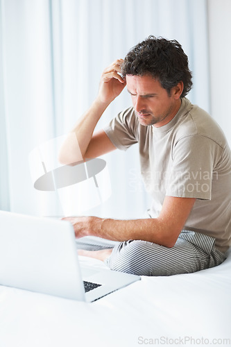 Image of Thinking, man in bedroom and laptop for work from home, confused and doubt in bed for freelance job. Technology, entrepreneur person and remote worker for online, company and marketing projects