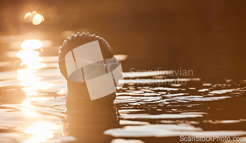 Image of A triathlete finds serene rejuvenation in a lake, basking in the tranquility of the water after an intense training session