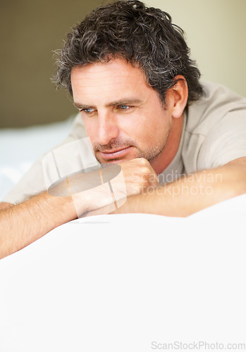 Image of Thinking, relax and mature man in bed in the morning after nap, break or comfortable sleep at home. Smile, idea and male person from Canada wake up in bedroom for rest on cozy day in apartment.