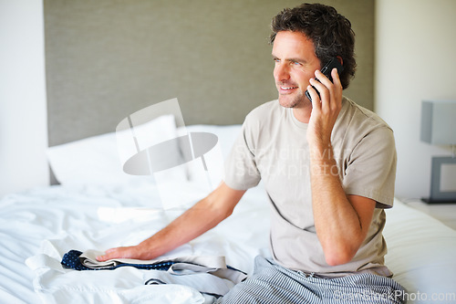 Image of Phone call, home and business man with clothes in bedroom getting ready for work, job and career. Technology, communication and happy person with tie on cellphone for conversation, chat and contact
