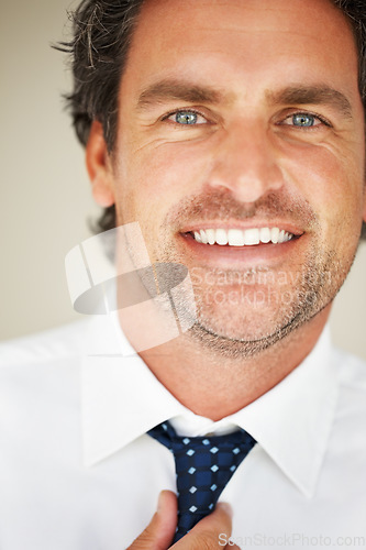 Image of Man, portrait and tie with smile for dressing, morning routine and formal style for corporate job in studio. Businessman, face and happy with getting ready, confidence and pride on beige background