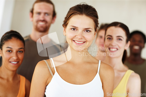 Image of Portrait, smile or fitness and woman with a group of people in a studio for health, wellness or mindfulness. Exercise, training and pilates with happy young friends together in gym class for workout