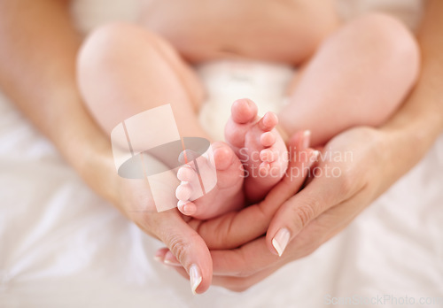 Image of Woman, child and feet holding for love connection or childhood bonding, motherhood or newborn. Female person, infant and toes or care support for kid growth development, parent trust or nurture youth