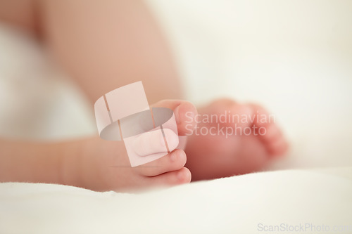 Image of Child, newborn and feet or toes closeup or infant development, safety care or growth support. Baby, foot and soft skin asleep for healthy birth on blanket love or tiny legs or wellness, youth in home