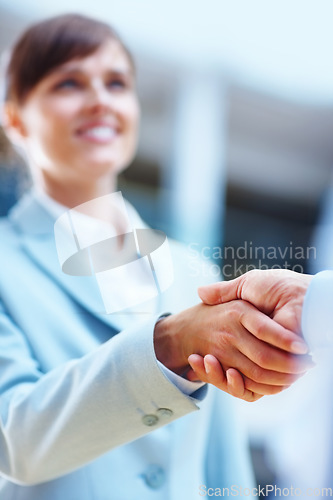 Image of Happy business people, handshake and meeting for b2b, partnership or corporate deal at office. Businessman and woman shaking hands in greeting, introduction or company agreement together at workplace