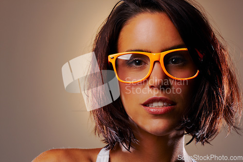 Image of Portrait, woman and face with spectacles in studio on brown background for fashion mock up with vision. Closeup, female model and glasses for eyesight in satisfaction for cool, new or trendy frames