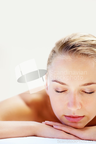 Image of Woman, sleeping and closeup on bed in spa for health, wellness and recovery with rest, peace and quiet. Girl, mockup space and resort for rehabilitation, massage and physical therapy for body fatigue