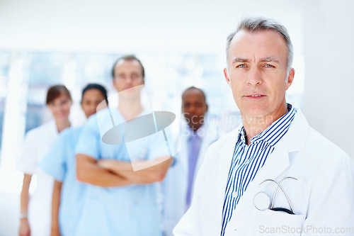 Image of Doctor, man and portrait of expert with medical, healthcare and clinic staff in a hospital. Teamwork, leadership job and stethoscope of a nurse and surgeon with professional team ready for working