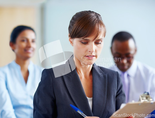 Image of Business woman, writing and clipboard in meeting, presentation or corporate workshop at office. Female person or employee taking notes in staff training, team conference or seminar at workplace