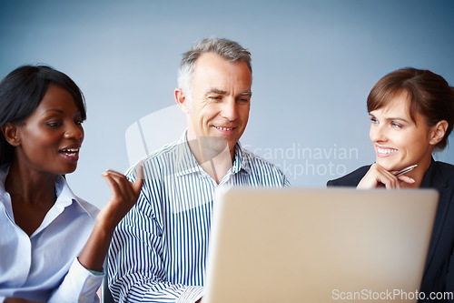 Image of Collaboration, business people and planning with a laptop in the boardroom for vision or strategy. Smile, meeting or diversity with corporate men and women working on a computer for company teamwork