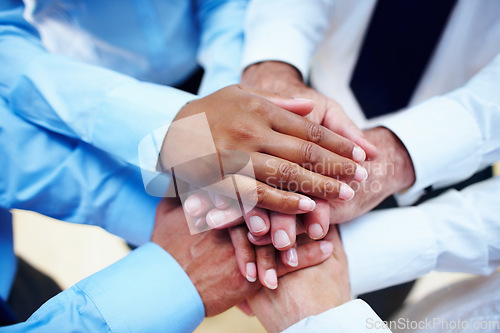 Image of Business people, hands together and teamwork for motivation, unity or collaboration at office. Group of employees piling for building, diversity or meeting in trust, community or support at workplace