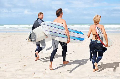 Image of Surfer friends, running and back at beach with board, training or fitness on vacation in summer. Men, woman and surfboard for wellness, health or workout by ocean, waves or freedom on holiday on sand