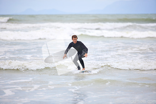 Image of Surfer man, waves and board with balance, fitness and training for health, wellness and freedom in summer. Person, surfing and outdoor for sports, exercise and adventure at sea, ocean and sunshine