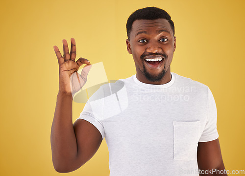 Image of African man, ok sign and studio portrait for smile, wow and surprise for review, vote or like by yellow background. Person, hand and emoji for feedback, choice or decision with icon, symbol and happy