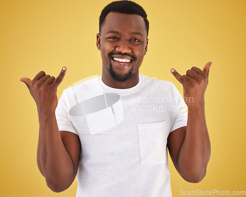 Image of Man, portrait and cool hand gesture in studio on yellow background for hang loose, good mood or relax weekend. Black person, model and face for finger emoji for chill out, stress relief or greeting
