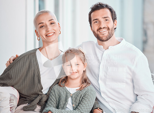 Image of Mother, father and girl on couch, portrait and smile with care, bonding and hug for love in home living room. Mom, dad and child with happy embrace on lounge couch, relax and pride in family house