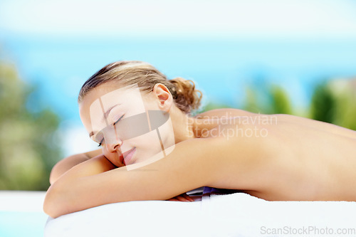 Image of Woman, sleeping and outdoor on bed at spa for health, wellness or recovery with rest, peace or quiet. Girl, sunshine and resort for rehabilitation, calm or physical therapy treatment for body fatigue