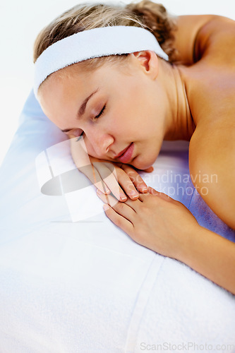 Image of Spa, massage and woman sleeping ready for back care for wellness and health in a salon. Resort, masseuse table and calm female person with zen and pamper treatment for beauty and stress relief