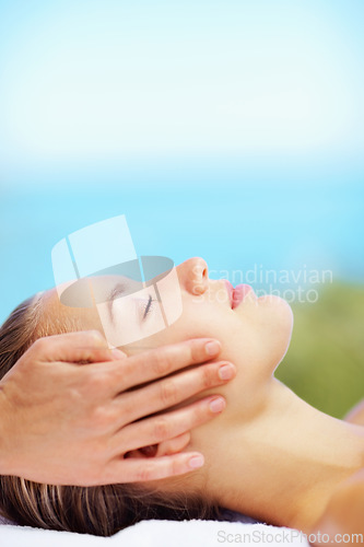 Image of Woman, head massage and bed at spa for health, wellness of rest in recovery, peace or quiet in nature. Girl, mockup space and resort in rehabilitation, massage or blue sky background for body fatigue