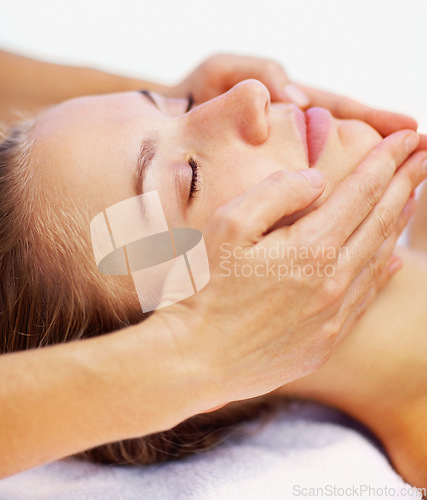 Image of Woman, relax and face massage with spa therapist for wellness, holistic therapy and reiki in studio on white background. Beauty, skincare and or client rest for facial acupressure, treatment or peace