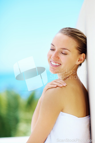 Image of Woman, wall and nature with skincare, health and hands with smile for results by blue sky background. Girl, touch skin and change with cosmetics, wellness and transformation with mockup space outdoor